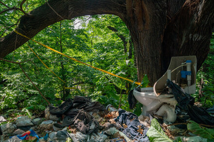 The baby, whom police identified as Genevieve Comager, was found Sunday night in the woods. Her parents were charged in connection with the death, according to police officials.