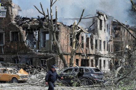 A Russian missile killed at least two people and wounded dozens more at a hospital, while apparent Ukrainian strikes hit occupied cities in the south.