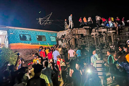 Video shows rescuers attempting to free people trapped in the wreckage after two trains derailed in the eastern state of Odisha.
